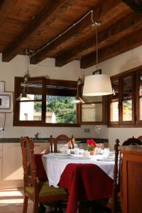 a dining room table with a red and white table cloth at Casa Morató in Beceite