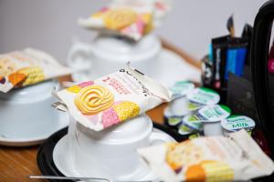 a table topped with white plates with cakes and cookies at The Windmill Inn in Watchet