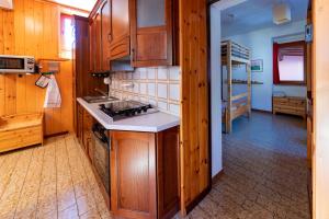 a kitchen with wooden cabinets and a stove top oven at Cariel in Antronapiana