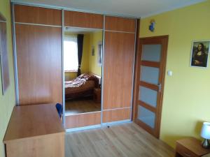 een kamer met een grote glazen kast en een slaapkamer bij Green Apartment z bezpłatnym parkingiem in Olsztyn