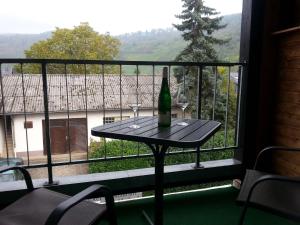 a bottle of wine sitting on a table in front of a window at Pleasing Apartment in Traben Trarbach with Balcony in Wolf