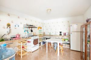 a kitchen with a white refrigerator and a table at Hotel Casa Poblana in Bacalar