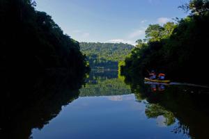 a man is in a boat on a river at Chacra del Agua Reserva Privada in Moconá Falls