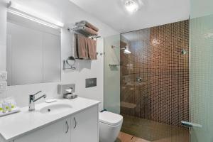 a bathroom with a toilet, sink, and shower at Quality Inn The George Hotel Ballarat in Ballarat