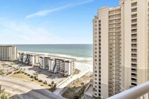 a view of the beach from the balcony of a building at Grand Panaama Beach Resort with ocean view in Panama City Beach