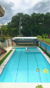 a large swimming pool with blue water in it at Villa Leah Natural Hotspring Resort in Calamba