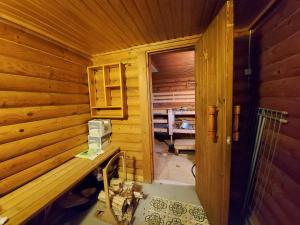 an inside view of a wooden cabin with a door at Rantamökki Onni in Hämeenlinna