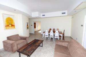 a living room with a couch and a table and chairs at Danara Place in Zinkwazi Beach