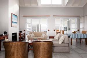 a living room with a couch and a table at Pinnacle Point Lodge 70 Golf and Spa Estate in Mossel Bay