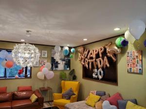 a living room with balloons and a couch and a chandelier at Asakusa Skytree View House in Tokyo