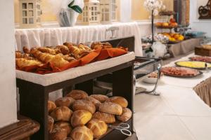 a table with a bunch of breads and pastries at Hotel Excelsior Splendide in Bellagio