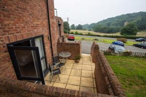 a balcony of a brick building with a table and chairs at The Windmill Inn in Watchet
