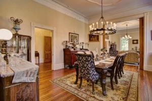 a dining room with a table and chairs at McMillan Inn in Savannah