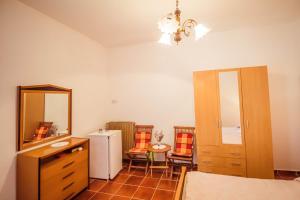 a bathroom with a sink and a mirror and a refrigerator at Room Luciana in Savudrija