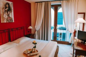 Postel nebo postele na pokoji v ubytování Hotel La Contrada