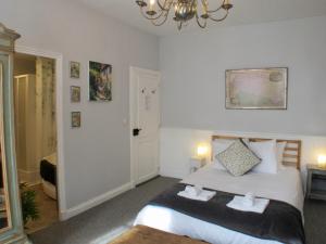 a bedroom with a bed and a chandelier at Les Deux Rives in Cierp