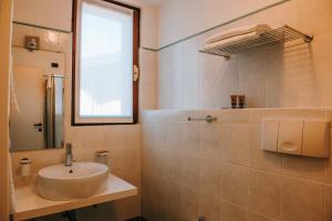 a bathroom with a sink and a mirror at Hotel La Contrada in Verbania