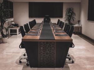 a large conference room with a long table and chairs at Towers Hotel alqassim in Buraydah