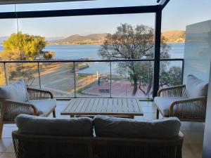 a living room with a view of the water at COZIDEA apartments CHALKIDA in Chalkida