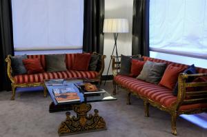 a living room with two couches and a coffee table at Hotel Principe Di Villafranca in Palermo