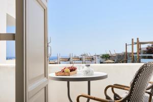 
a pizza sitting on top of a wooden table at Palladium Hotel in Platis Yialos Mykonos
