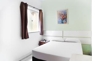 Cama o camas de una habitación en OYO Hotel Guarany