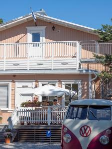 a man sitting at a table under an umbrella at B&B Villa Aurora in Hanko