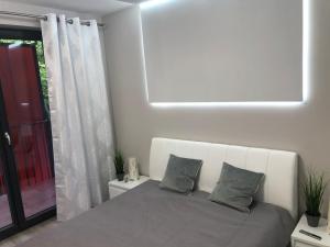 a bedroom with a bed with two pillows on it at Apartament Agnes Szczecin Pomorzany in Szczecin