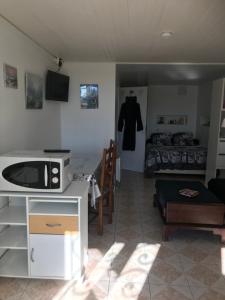 a living room with a kitchen and a bedroom at Charmant Studio meublé in Montignac-Charente
