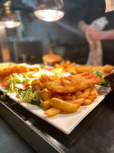 a plate of food with french fries and salad at The Kirkmichael Hotel in Kirkmichael