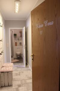 a bathroom with a door and a toilet at Klein Erna (Apth.Holländerei) in Büsum +11 photos