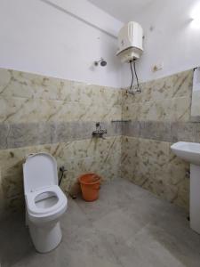 a bathroom with a toilet and a sink at Pemaling Lords Inn Dirang in Dirang Dzong
