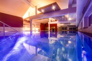 a large swimming pool in a building at 4*S Galtenberg Resort in Alpbach