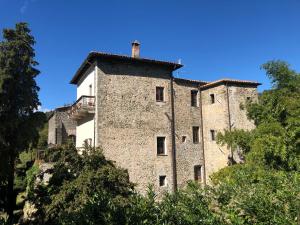 an old castle on top of a hill with trees at Castello del Poderetto in Licciana Nardi