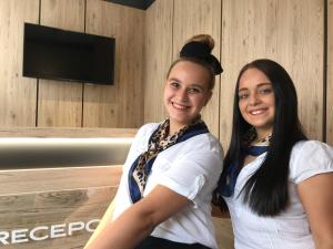 two women sitting next to each other in a room at Primma Hotel in Moldava nad Bodvou