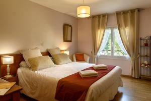 a bedroom with a large bed with a window at Maison de vacance La Cavalière in Accous