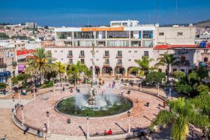 a fountain in the middle of a city at Hotel Posada Arcos in San Juan de los Lagos