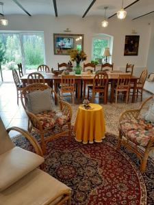 a dining room with a table and chairs at Na Łąkie in Szczecinek