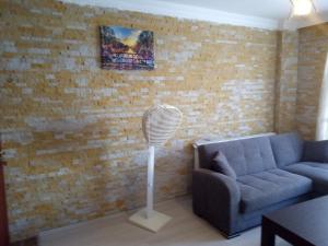 a living room with a couch and a fan at Asmir Suites Hotel in Nevşehir