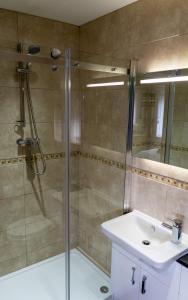 a bathroom with a shower and a sink at The Windmill Inn in Watchet