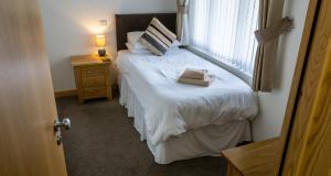 a bedroom with a bed with a large window at The Windmill Inn in Watchet