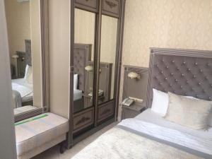 a bedroom with a bed and a large mirror at Old Town in Tomsk