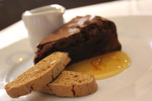 a plate with a chocolate cake and two pieces of bread at The Windmill Inn in Watchet