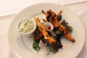 a plate of food with fries and dip on a table at The Windmill Inn in Watchet