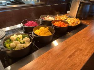 a group of bowls of different types of vegetables on a counter at The Windmill Inn in Watchet