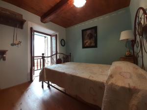 a bedroom with a bed in a room with a window at tana del paradiso due in Baceno +13 photos