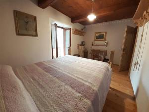 a bedroom with a large bed and a window at tana del paradiso due in Baceno