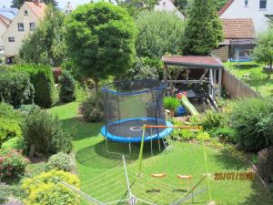 a backyard with a trampoline in the grass at Ruhiges Zimmer 2 in Angersbach