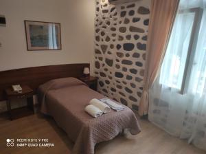 Posteľ alebo postele v izbe v ubytovaní Porto Lesvos hotel