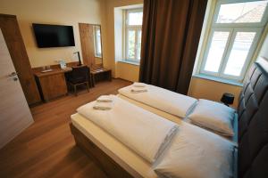 Postel nebo postele na pokoji v ubytování M-24 Apartments + 26 fotografií